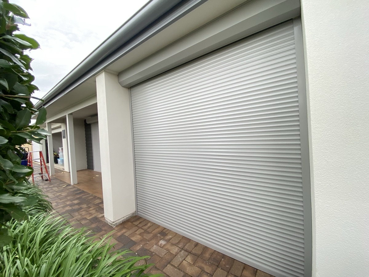 White roller shutters on columns